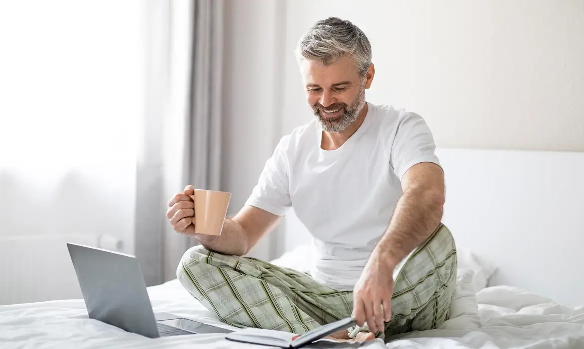 Man enjoying coffee and watching Laptop
