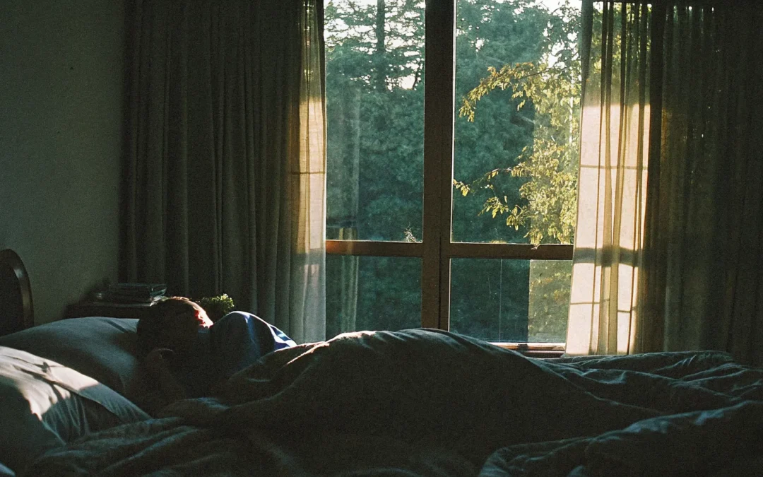 Person resting in a peaceful bedroom at dawn, representing circadian rhythm and sleep health